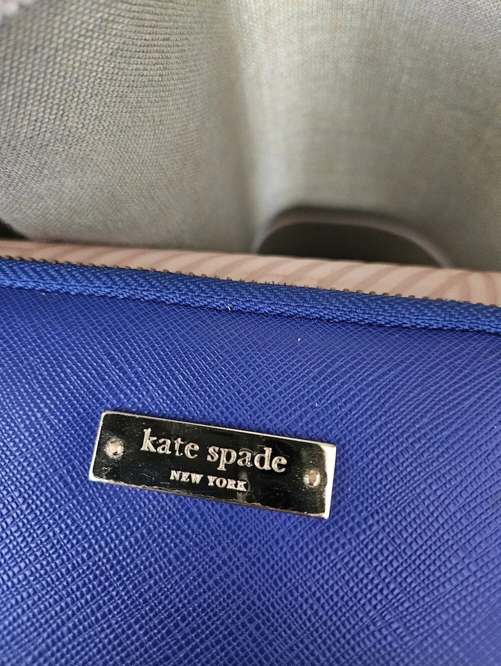 kate spade cobalt blue laptop sleeve with gold logo plaque